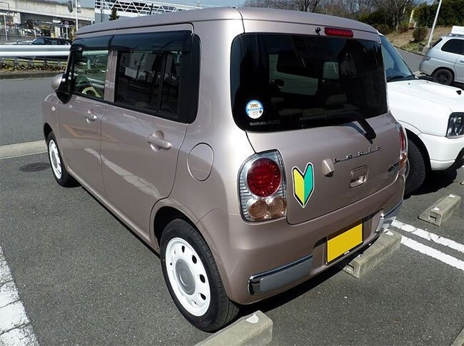 Picture 1 of Decipher the strange symbol that is stuck on cars in Japan