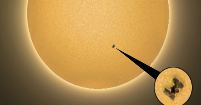 A shot of the ISS station flying over the Sun.