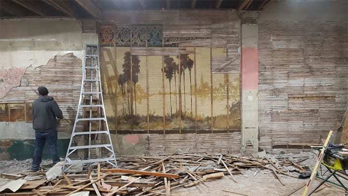 Picture 2 of A hundred-year-old 'terrible' painting is hidden in the wall of an old house