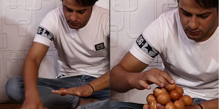 Picture 1 of Balancing 18 eggs on the back of his hand, the man sets a world record