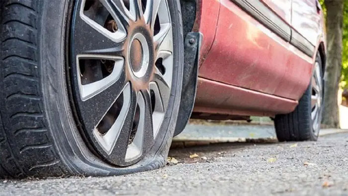 Picture 1 of Should you continue driving when your car has a punctured tire?