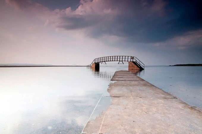 The bridge is suspended in the middle of the water with a path leading directly down to the 'aquarium' Picture 1
