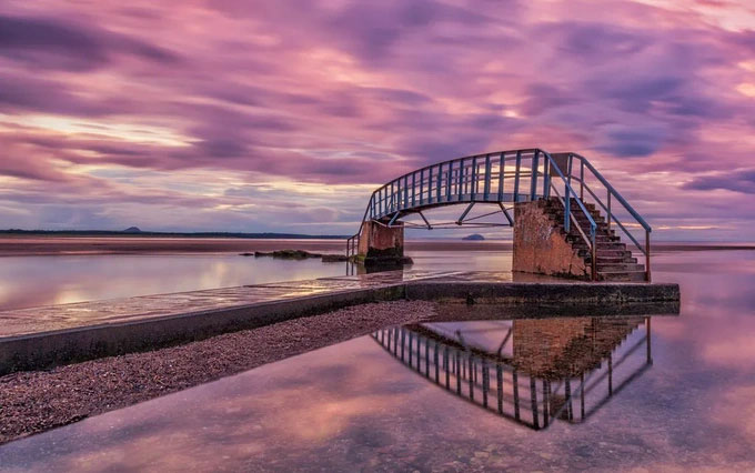 The bridge is suspended in the middle of the water with a path leading directly down to the 'aquarium' Picture 3
