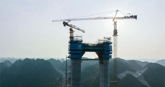 Breaking its own record, China continues to build the world's highest bridge above a 'crack in the Earth'