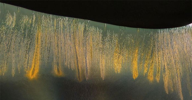 Find the strange 'glow' next to the Martian crater