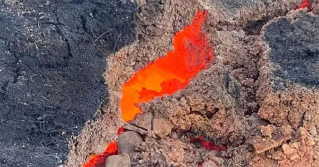 The rock glows bright red like volcanic lava