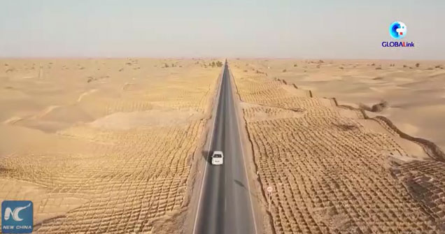 Video: Watch workers 'plant' hay to protect a road in the middle of China's largest desert
