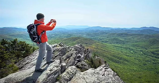 Why do people see mountains in the distance blue?