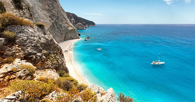 Why is it difficult to attract people to live on this beautiful island, which has houses provided by the government for 20,000 USD?