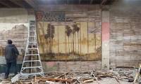 A hundred-year-old 'terrible' painting is hidden in the wall of an old house
