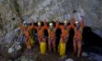 Astronauts crawl into the cave to train