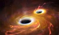 Discovering the first merging galactic cores at the dawn of the universe