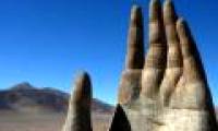 In the driest desert in the world, there is a giant hand that is calling for help.