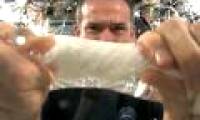 Video: A miserable astronaut squeezes a wet towel on a space station