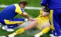 What is a football player spraying on a sore wound when he is hurt on the field?