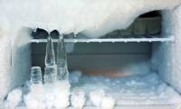Why does the refrigerator freeze and should this layer of snow be removed?