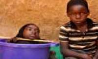 Young woman living in plastic pots for strange disease